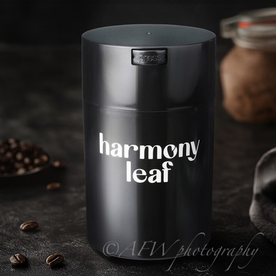 Black metallic coffee container storing roasted coffee beans on